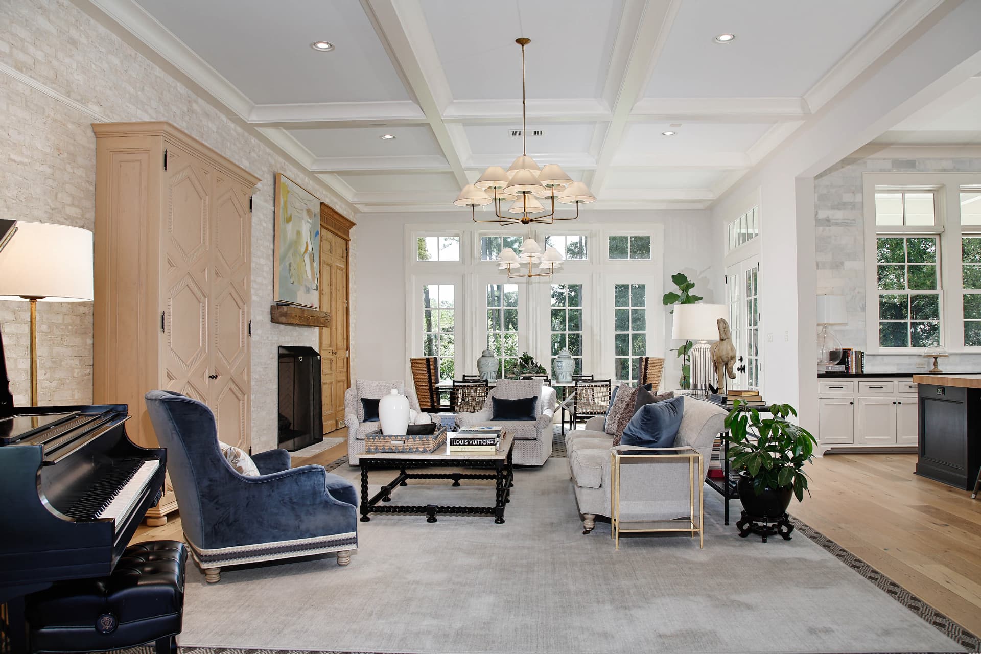 Elegant living room with detailed millwork, white oak floors, and a statement chandelier